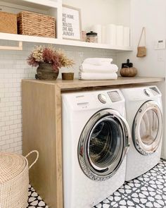 a washer and dryer in a room with black and white tile flooring