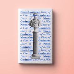 a book with an image of a statue on the front and back cover, against a pink background