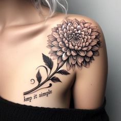 a woman's shoulder with a flower tattoo on it that says keep it simple