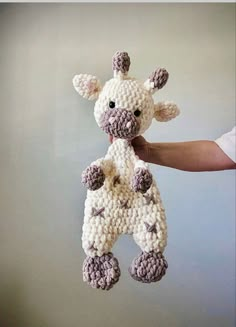 a crocheted giraffe hanging from a string