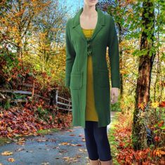 "*Long fitted vest/jacket made of 100% boiled wool. The boiled wool is knitted, so slightly stretching which makes it very comfortable to wear. Also the buttons are made of boiled wool. The inner and outer seams as well as the hems are finished with rustic cocotted stitches. With this design we have strived for a garment which is easy to recycle: on the way to a waste- free society where everything is recyclable or at least biodegradable we chose with this design to start from 100% monomaterial. Cashmere Sweater Coat With Buttons For Winter, Fitted Cashmere Outerwear For Layering, Winter Cashmere Sweater Coat With Buttons, Fitted Merino Wool Cardigan, Fall Merino Wool Outerwear With Buttons, Single Breasted Wool Cardigan For Fall, Winter Wool Single-breasted Cardigan, Green Merino Wool Long Sleeve Outerwear, Fitted Wool Coat For Cold Fall Weather