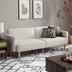 a living room scene with focus on the couch and coffee table in the foreground