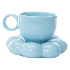 a blue cup and saucer sitting on top of each other