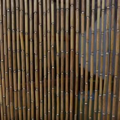 a close up view of the side of a bamboo fence