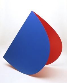 a blue and red object sitting on top of a white table next to each other