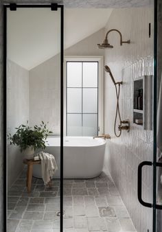 a bathroom with a bathtub, shower and window