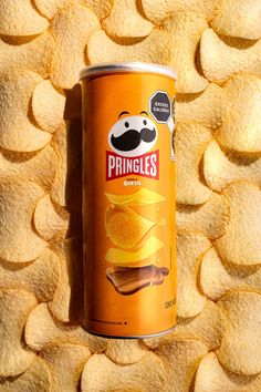 a can of pringles sitting on top of a pile of chips