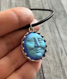 This is a listing for the 1"  iridescent Blue Moon Face charm necklace.   The necklace is a 3mm, 18" long leather cord with a lobster claw clasp. Blue Moon Necklace, Necklace Moon, Face Necklace, Moon Face, Iridescent Blue, To The Moon And Back, Necklace Blue, Moon Necklace, Blue Moon