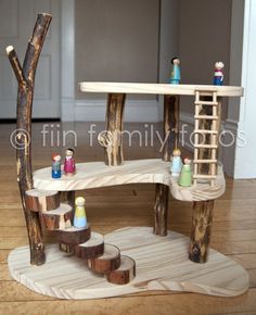 a wooden table and ladder made out of logs on top of a hard wood floor