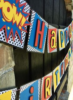 a happy birthday banner is hanging on the wall in front of a door with an arrow