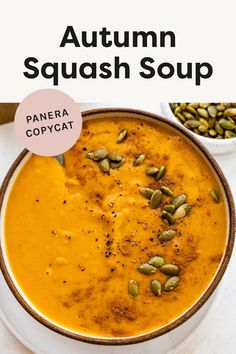 a white bowl filled with pumpkin squash soup and topped with pistachio seeds on top