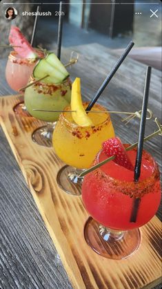 three different types of drinks on a wooden tray