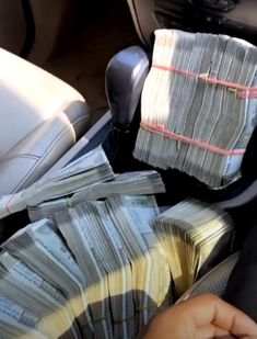 a bunch of money sitting in the back seat of a car