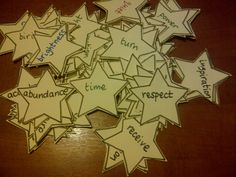 a bunch of stars that are on top of a wooden table with words written in them