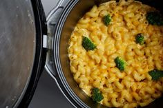 a pot full of macaroni and cheese with broccoli