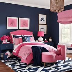 a bedroom with blue walls and pink accents