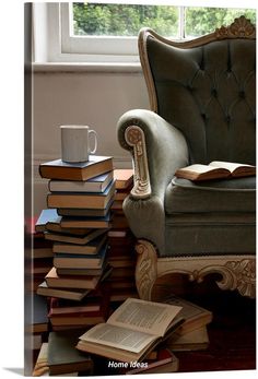 a stack of books sitting on top of a chair next to a window