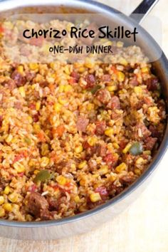 a skillet filled with mexican rice and corn next to a wooden cutting board that says chorizo rice skillet one - dish dinner