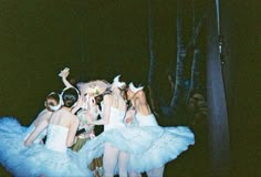 several ballerinas dressed in blue tutus and white dresses