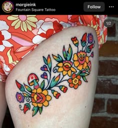 a woman's thigh with flowers painted on it and the words, feminine square tattoo below