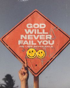 a red sign that says god will never fail you with two smiley faces on it