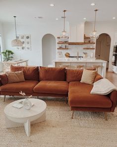 a living room filled with furniture next to a kitchen and breakfast nooks on top of each other