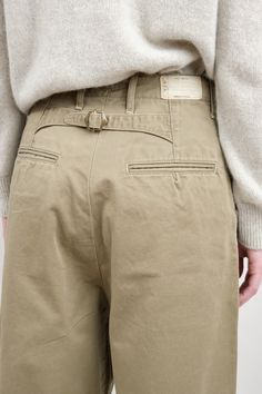 The Chino High Waist NIME Pants are a slightly oversized barrel leg pant with front pleats. Featuring the signature Kapital posterior waist buckle, these pants are a take on a classic trouser with a touch of modern style. Fasteners Clothing, Khaki Color Combination, Chinos Women Outfit, Bush Pants, Menswear Pants, Sunday Market, Beige Chinos, Womens Chinos, Khaki Chino Pants