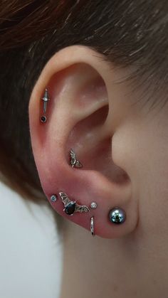 a person with some piercings on their ears and behind them is an ear pin