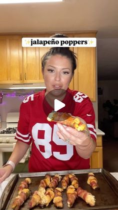 a woman in a red shirt holding a plate of food