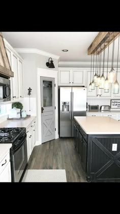 a kitchen with white cabinets and black appliances