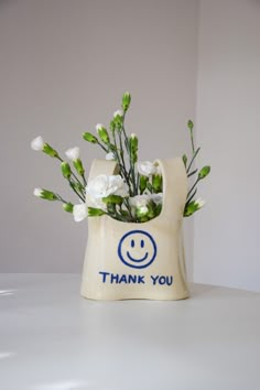 a vase with flowers in it that says thank you