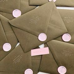 some brown envelopes with pink seals on them