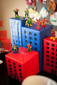 some toy figurines are sitting on top of cubes in the shape of buildings