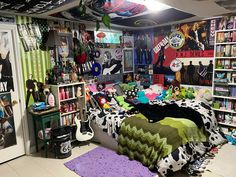 a room filled with lots of books and stuffed animals on the floor next to a bed