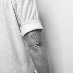 a man's arm with a tattoo on it that reads, at the top