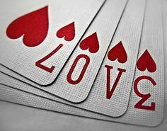 four playing cards with the word love spelled in red and white on each card is an ace symbol