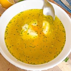 a white bowl filled with soup next to an orange