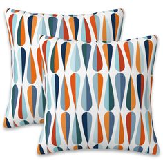 two pillows with colorful shapes on them, one is blue and the other is orange