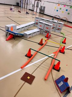 an indoor track set with orange cones and obstacles