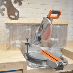 a circular saw is being used to cut plywood planks with a miter