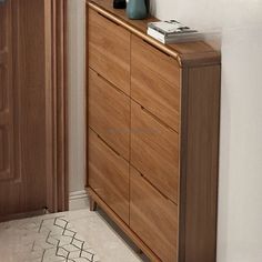 a wooden dresser sitting in the corner of a room