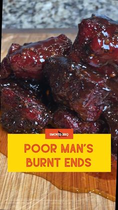 a close up of food on a wooden cutting board with the words poor man's burnt ends