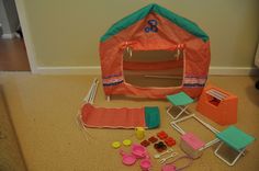 a doll house with furniture and accessories on the floor