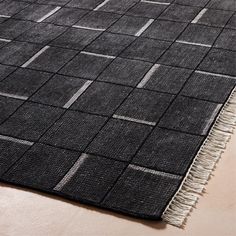 a black and white rug with fringes on it