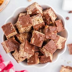 a white bowl filled with chocolate fudges on top of a red and white checkered table cloth