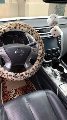 the interior of a car with leopard print steering wheel cover