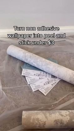 a roll of toilet paper sitting on top of a pile of money next to a plastic bag