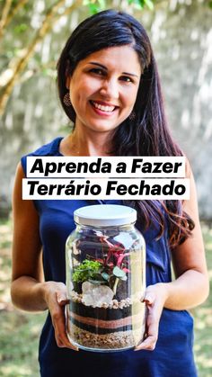 a woman is holding a jar with plants in it