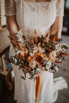 a woman holding a bouquet of flowers in her hands