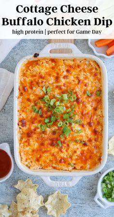 a casserole dish with cheese and green onions in it, surrounded by tortilla chips